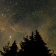 In this 30 second exposure, a meteor streaks across the sky during the annual Perseid meteor shower, Wednesday, Aug. 11, 2021, in Spruce Knob, West Virginia.